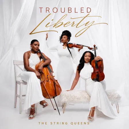 Three women in white dresses playing string instruments, with the text "Troubled Liberty" and "The String Queens" displayed.